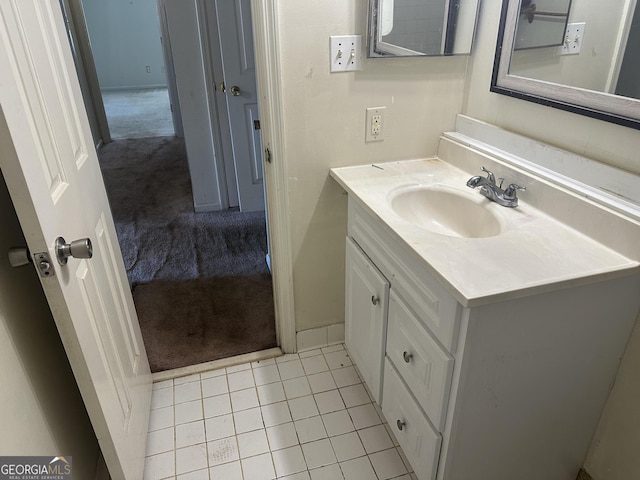 bathroom with tile patterned floors and vanity