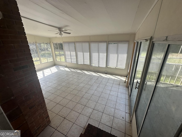 unfurnished sunroom featuring ceiling fan