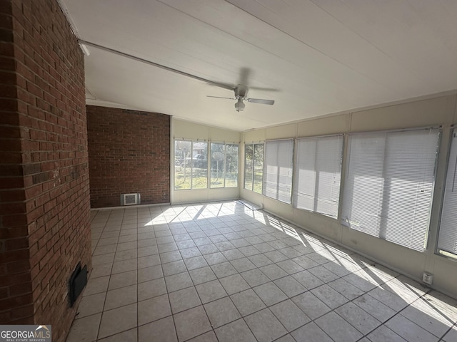 unfurnished sunroom with visible vents and ceiling fan