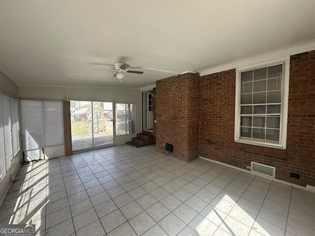 unfurnished sunroom featuring visible vents and ceiling fan