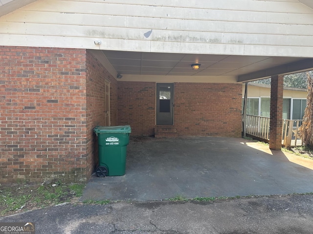 view of patio / terrace with entry steps and an attached carport