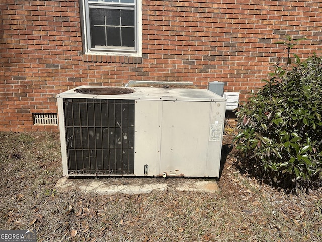 details featuring brick siding and central AC