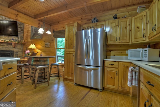 kitchen featuring wood ceiling, light wood-type flooring, appliances with stainless steel finishes, and beamed ceiling