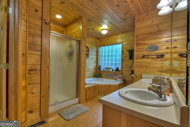 full bathroom with visible vents, wood ceiling, a garden tub, a stall shower, and a sink