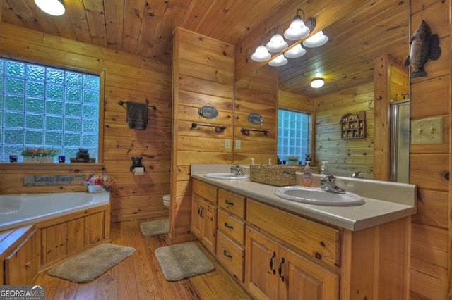 bathroom with toilet, wood ceiling, double vanity, wood finished floors, and a sink