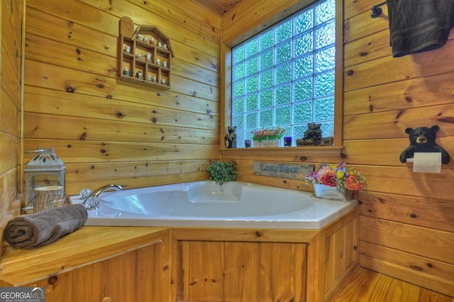 full bath with wooden walls and a garden tub