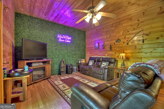 living area featuring wood finished floors, wooden ceiling, and a ceiling fan