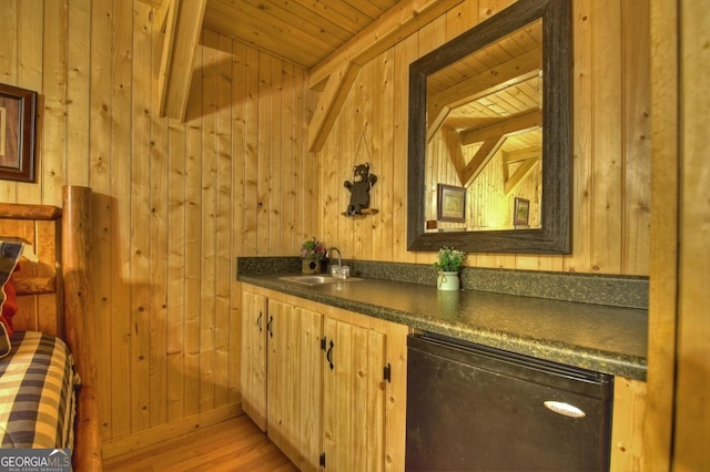 bar featuring indoor wet bar, wood walls, wood ceiling, and a sink