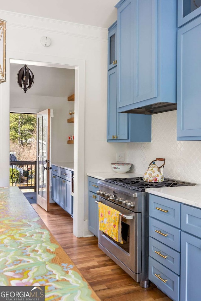 kitchen featuring blue cabinetry, light wood-type flooring, and high end stove