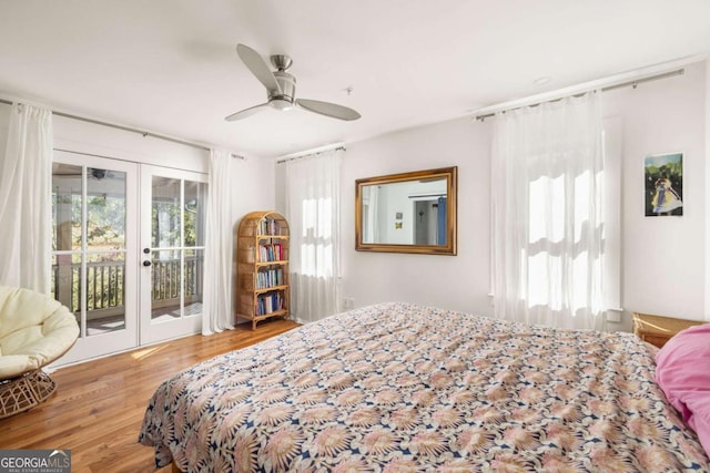 bedroom featuring a ceiling fan, access to exterior, wood finished floors, and french doors