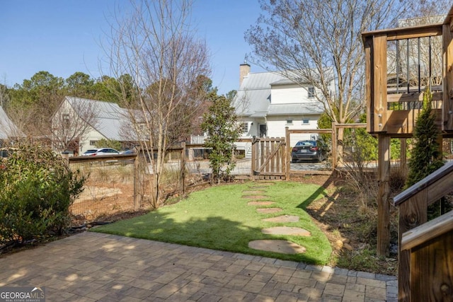 view of yard featuring a gate, a patio, and fence