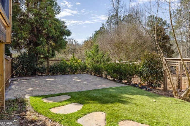 view of yard featuring a patio and fence