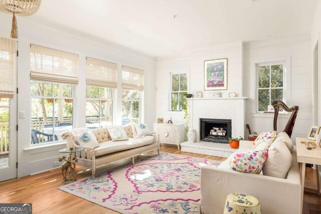 sunroom featuring a brick fireplace