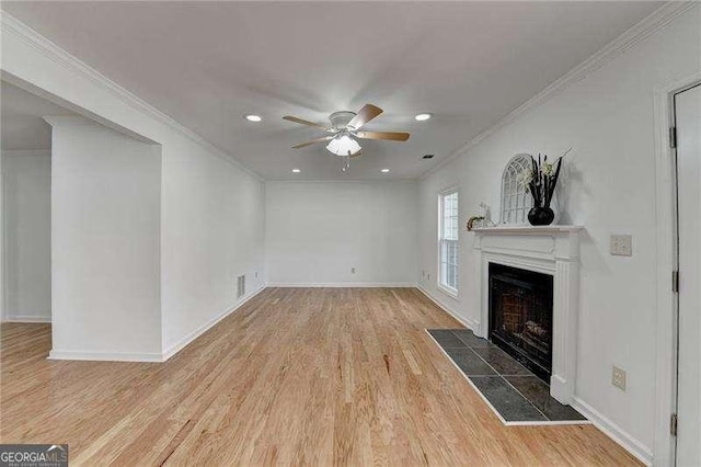 unfurnished living room featuring a ceiling fan, wood finished floors, a fireplace, and ornamental molding