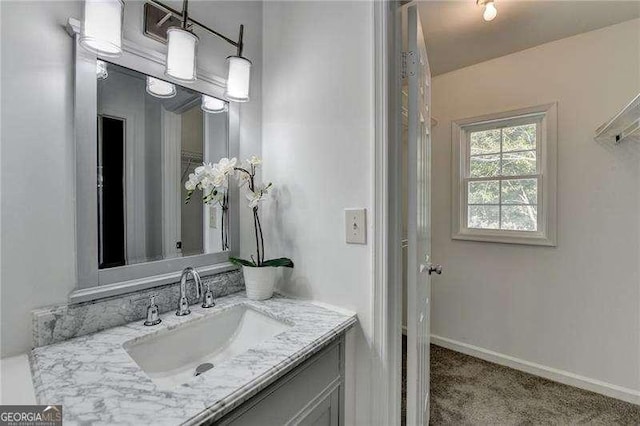 bathroom featuring vanity and baseboards