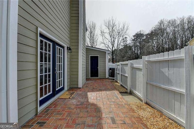 view of patio / terrace featuring french doors and fence