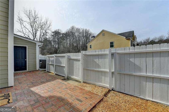 view of patio / terrace with central AC and fence