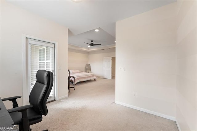 home office featuring a raised ceiling, recessed lighting, carpet flooring, baseboards, and ceiling fan