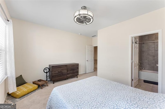 carpeted bedroom featuring ensuite bath