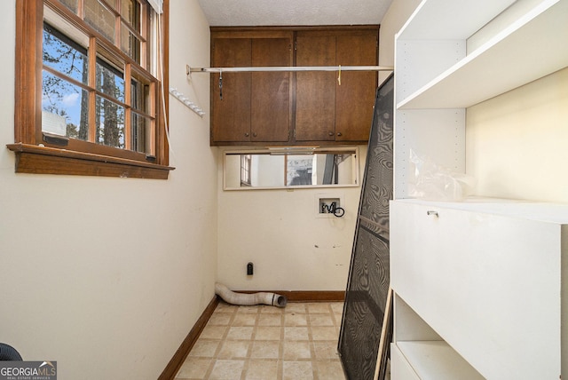 clothes washing area featuring electric dryer hookup, baseboards, light floors, hookup for a washing machine, and laundry area