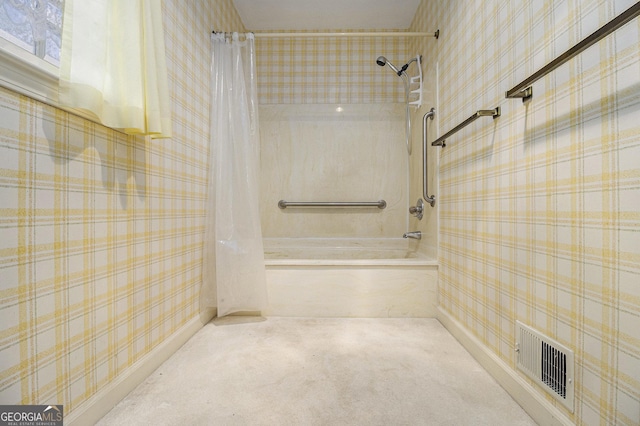 bathroom with visible vents, shower / bath combination with curtain, and wallpapered walls