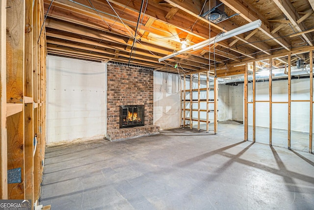 unfinished below grade area featuring a fireplace