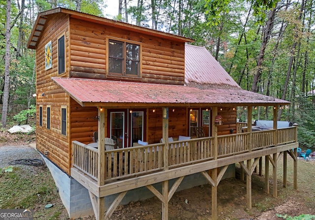 view of front of home with metal roof and log veneer siding