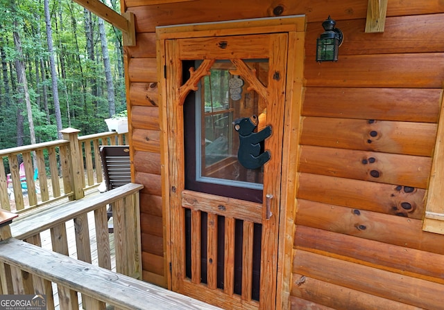 entrance to property with faux log siding