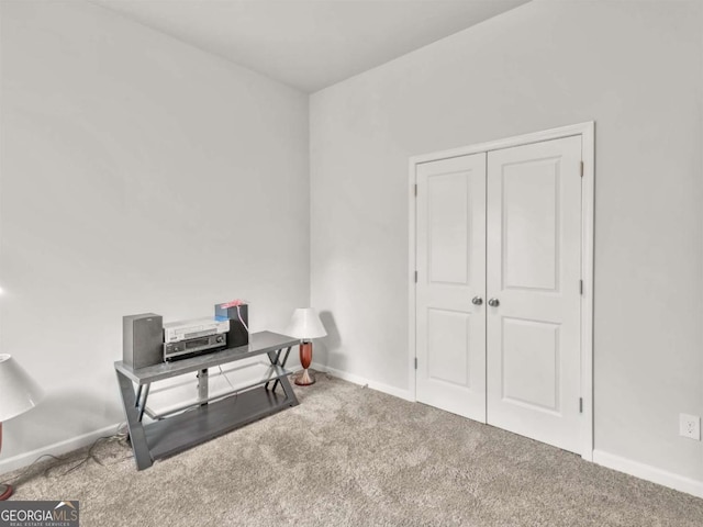 interior space with baseboards and carpet flooring