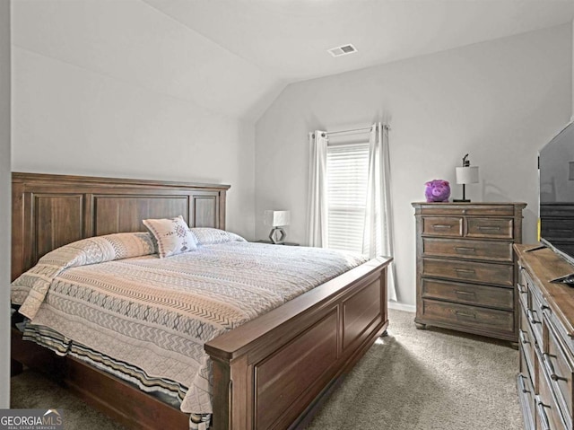 bedroom featuring light carpet, visible vents, and vaulted ceiling