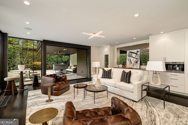 living area with recessed lighting, expansive windows, and wood finished floors