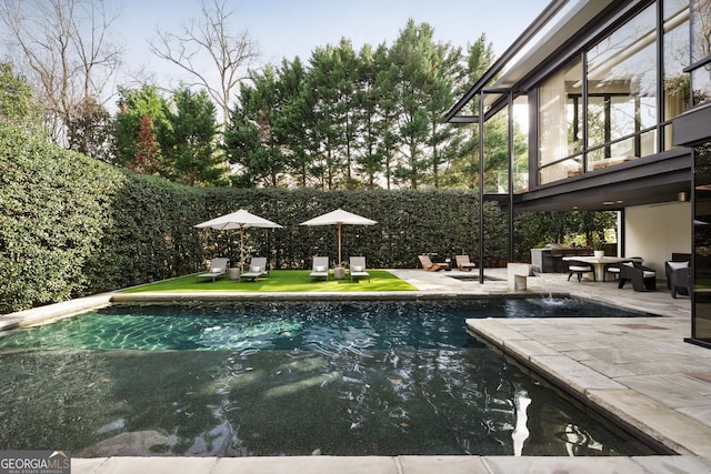 view of swimming pool featuring outdoor lounge area, a patio, a fenced in pool, and fence