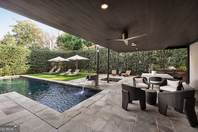 pool with a patio, a ceiling fan, and a fenced backyard