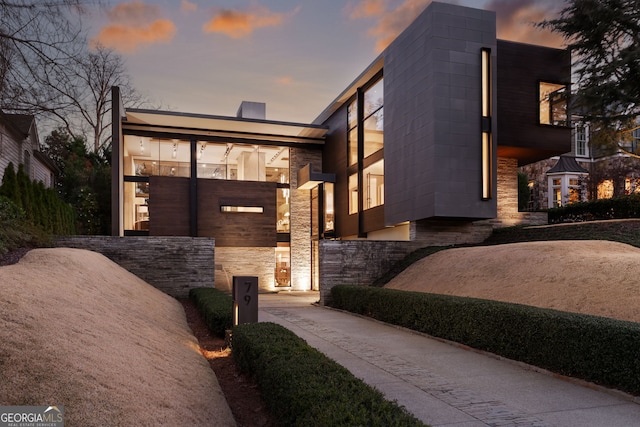 contemporary house featuring stone siding