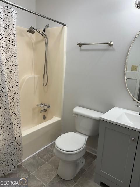 full bath with tile patterned floors, toilet, vanity, and shower / bath combination with curtain