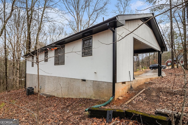 view of side of home with central AC and crawl space