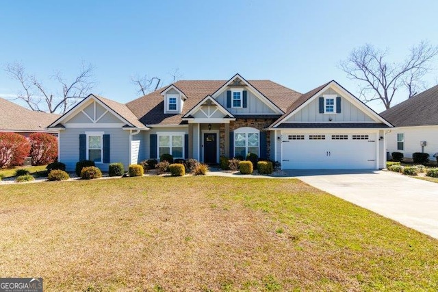 craftsman house featuring board and batten siding, a front lawn, concrete driveway, a garage, and stone siding