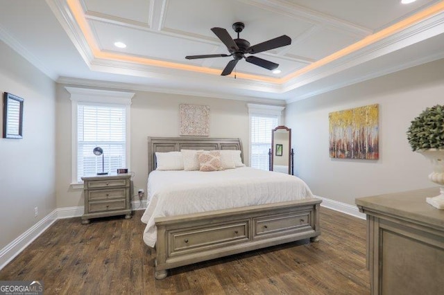 bedroom with dark wood-style floors, a raised ceiling, baseboards, and ornamental molding