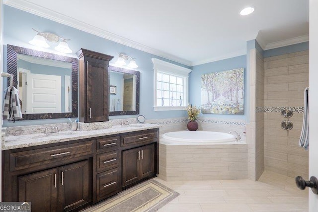 full bath featuring double vanity, crown molding, a garden tub, and a sink