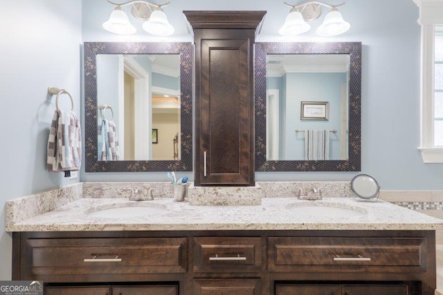 bathroom with double vanity, ornamental molding, and a sink