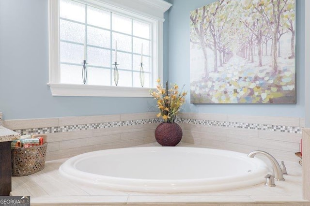 full bath featuring vanity and a garden tub