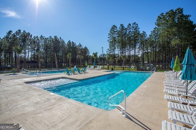 pool featuring a patio area and fence