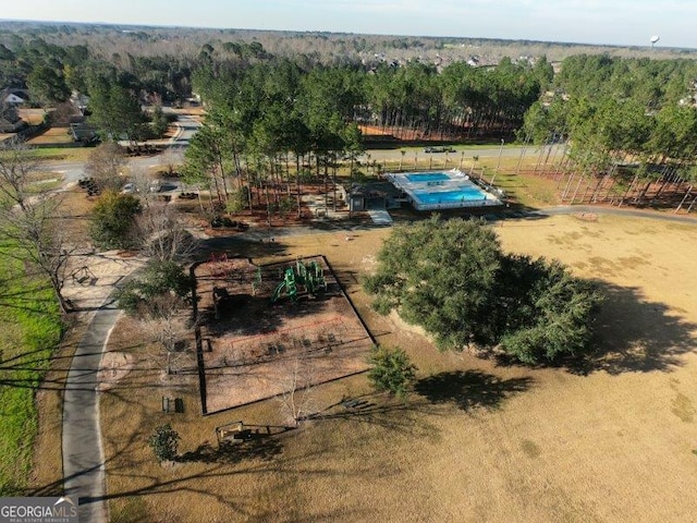 birds eye view of property with a wooded view