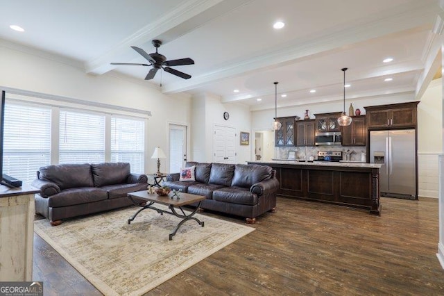 living area featuring beam ceiling, recessed lighting, dark wood-style flooring, ornamental molding, and ceiling fan