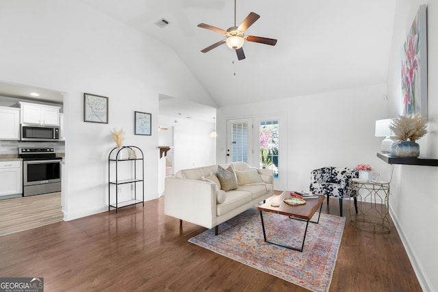 living room featuring baseboards, high vaulted ceiling, wood finished floors, and a ceiling fan