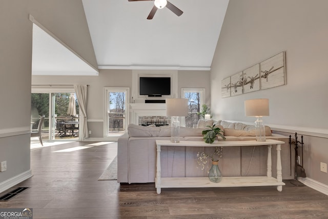 unfurnished living room featuring a wealth of natural light, visible vents, high vaulted ceiling, and wood finished floors