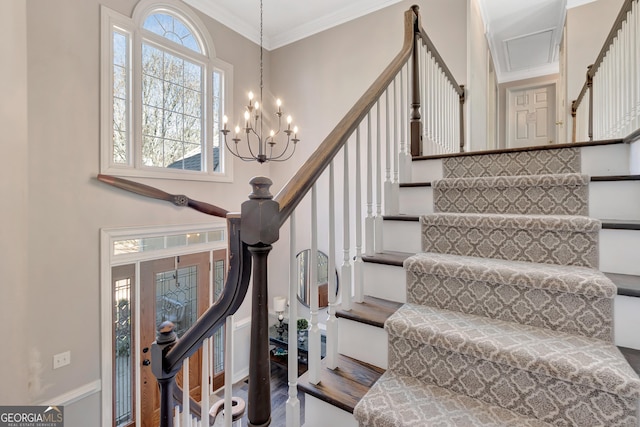 stairs featuring an inviting chandelier and ornamental molding