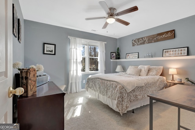 carpeted bedroom featuring visible vents and ceiling fan