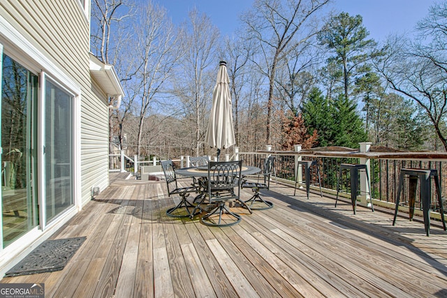 wooden terrace with outdoor dining space