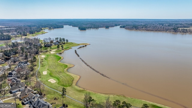 drone / aerial view featuring golf course view and a water view